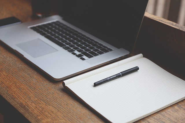 Laptop and notebook with blank page